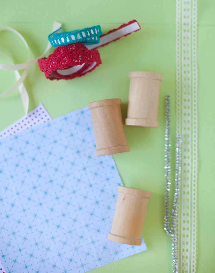 All the items you'll need to make wooden spool handmade ornaments. Including wooden spools, patterned paper, trim, and chenille pipe cleaner