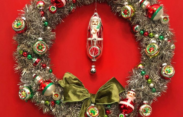 Vintage Inspired tinsel wreath with Shiny Brite ornaments against a red background