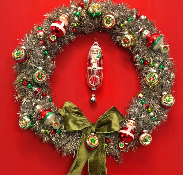 Vintage Inspired tinsel wreath with Shiny Brite ornaments against a red background