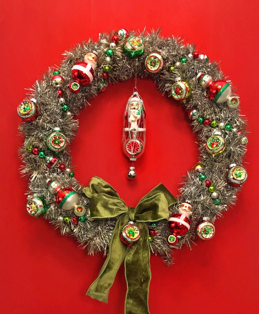 Vintage Inspired tinsel wreath with Shiny Brite ornaments against a red background