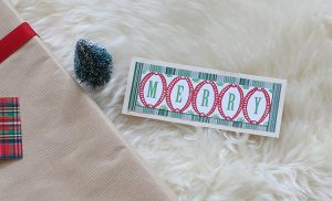 Upcycled holiday gift wrap with Merry text.