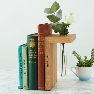 Personalized wood bookend with a hole for a small glass flower vase.