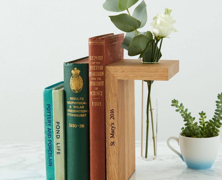 Personalized wood bookend with a hole for a small glass flower vase.