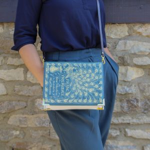 Cross-body purse with a blue and gold "Pride and Prejudice" book cover printed on the flip.