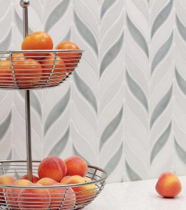 White and gray backsplash tiles in the shape of a braided leaf.