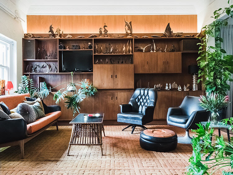 A collection of vintage furniture and cabinets that steal the show with their aged black and brown exteriors.
