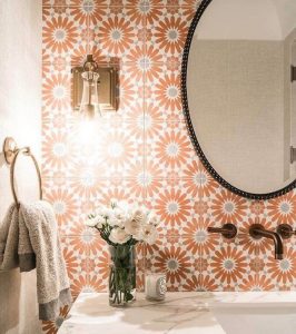 Red and white backsplash tiles in the shape of suns.