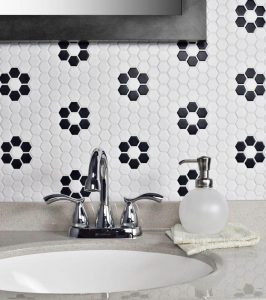Black and white hexagonal backsplash tiles that form a daisy shape.
