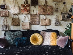 An array of antique purses in different shapes, styles, and colors as a part of Victoria's vintage collectibles.