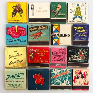 An array of cardboard boxes with small designs on the top for vintage sellers.