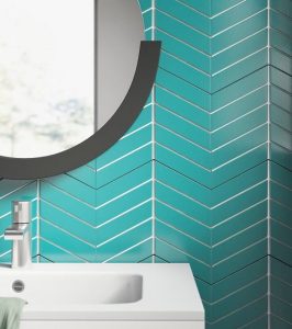 Chevron backsplash tiles colored a light turquoise.