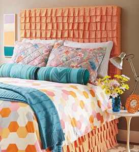 Orange headboards made from fabric that is cut in an array of tiny squares.