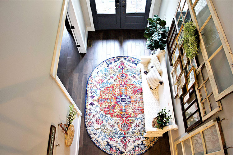 An aerial view of a vintage styled entryway and a colorful rug.
