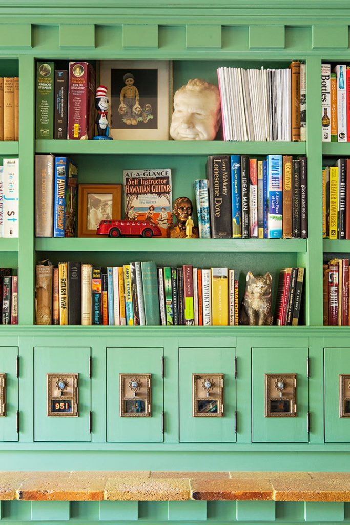 A bookshelf and toy chest painted a sea foam green color.