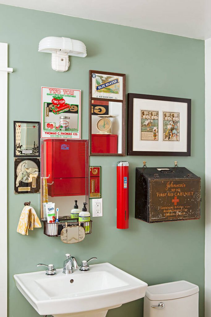 Diverse antiques placed above a bathroom sink.