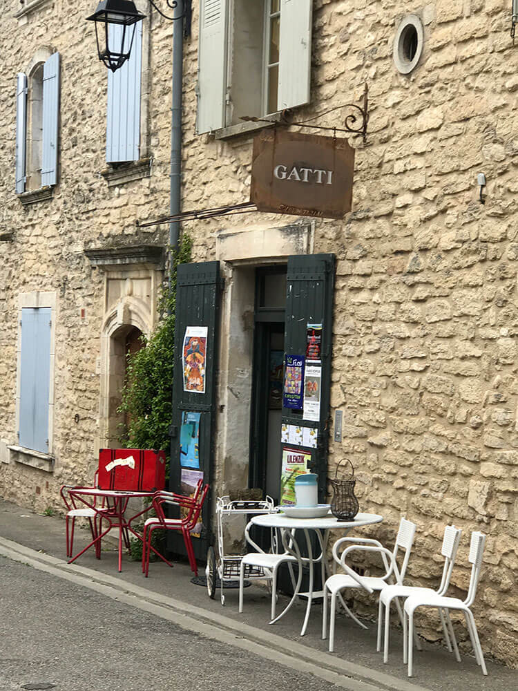 An art gallery sign and doorway in the town of Goult.