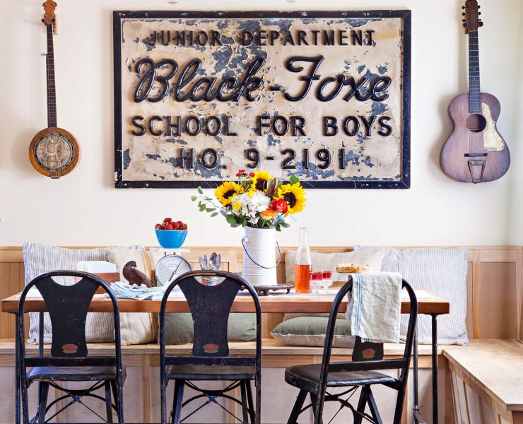 A rustic renovation featuring the dining room composed of antique signage and guitars.