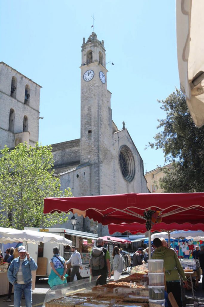 A Provence market showcasing its red awnings.