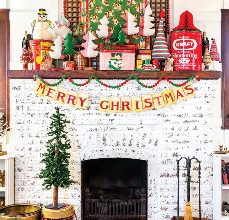 fabric trees, felt garland and other flea market finds on Christmastime mantel