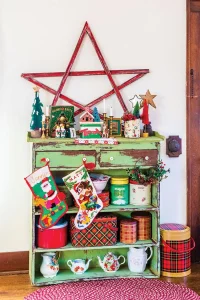 vintage cabinet displaying vintage tins teapots and pitchers