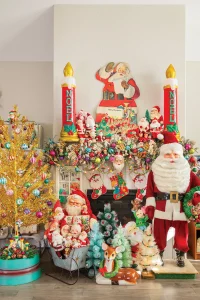 vintage Santas and reindeer and ornaments create a maximalist vintage holiday mantel