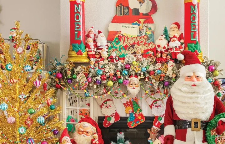 vintage Santas and reindeer and ornaments create a maximalist vintage holiday mantel