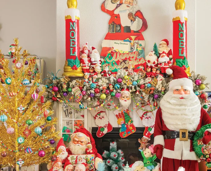 vintage Santas and reindeer and ornaments create a maximalist vintage holiday mantel