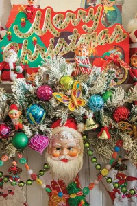 vintage Merry Christmas sign and garland of ornaments and Santa face