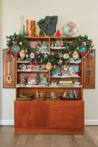 shelves showcasing collection of vintage holiday ornament boxes and figurines