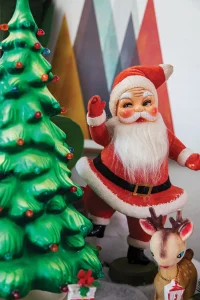 whimiscal holiday vignette with Santa figurine reindeer and tree