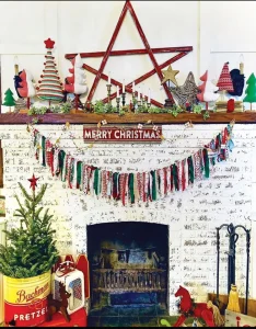 large vintage tin used to house small Christmas tree and handmade garland from fabric scraps