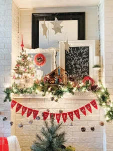 mantel decorated for Christmas with pinecones and mini tree