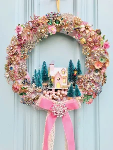 elegant wreath made of vintage jewelry and small bottle brush tree and pink putz house