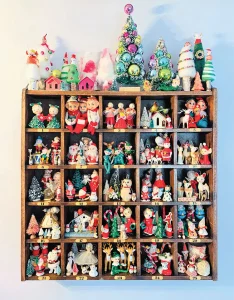 vintage cabinet with cutouts filled with vintage elves