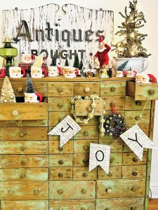 apothecary cabinet with Santa mug and figurine collection