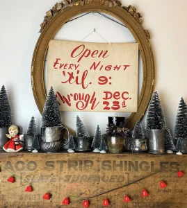 vintage style handwritten sign and collection of bottlebrush trees in home featured in Santa Stoppers 2021 gallery