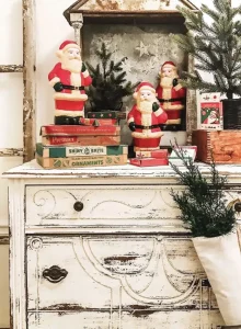 vintage Santa figurines atop boxes of Shiny Brite ornaments