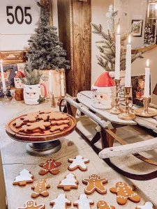 gingerbread cookies on display alongside vintage sled and Santa mugs