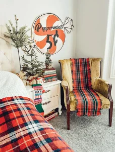 vintage peppermint sign and stack of vintage books serves as tree stand