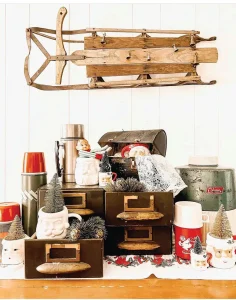 vintage sled with vintage thermoses and Santa mugs