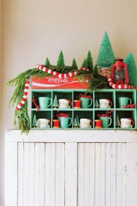 vintage Coca-Cola box and jadeite mugs on display Santa Stoppers 2021