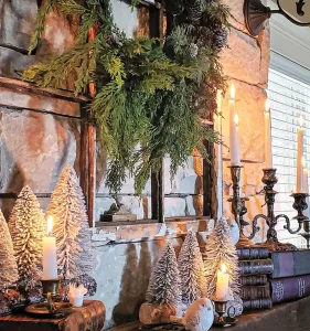 white mini trees and cedar wreath and antique books