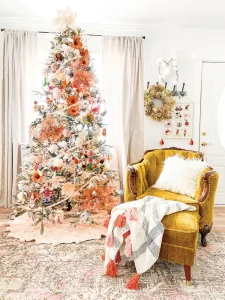 vintage chartreuse colored chair next to Christmas tree with white and peach and coral palette