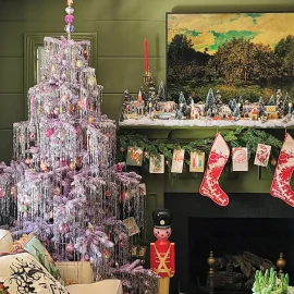 artificial tree decked with tinsel and vintage ornaments with vintage Putz houses on mantel