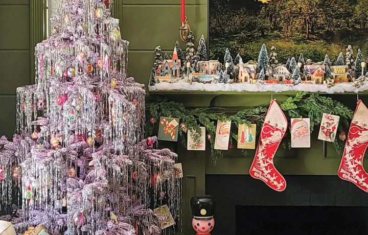 artificial tree decked with tinsel and vintage ornaments with vintage Putz houses on mantel