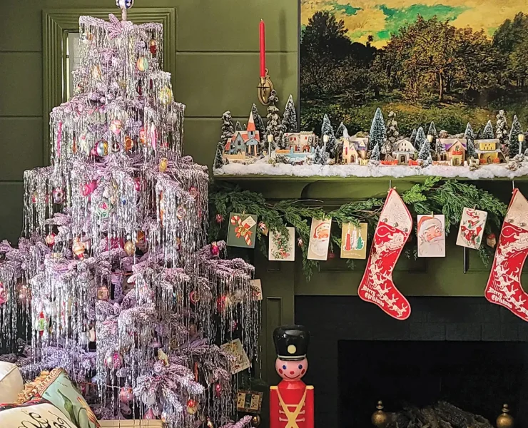 artificial tree decked with tinsel and vintage ornaments with vintage Putz houses on mantel