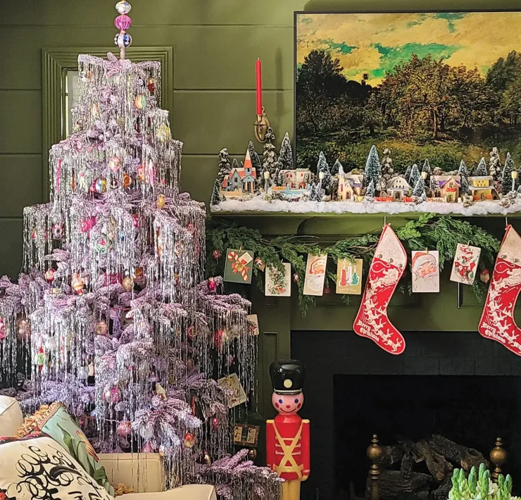 artificial tree decked with tinsel and vintage ornaments with vintage Putz houses on mantel