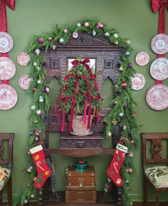 antique wood furniture decorated for Christmas with ribbons and garlands