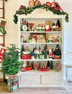 display shelf with bottlebrush trees, raggedy Ann dolls and jadeite