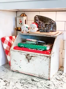 vintage breadbox with Mr and Mrs Clause heads and Santa etching